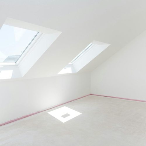 Loft refurbishment - empty room with skylight ready for renovation and new floor